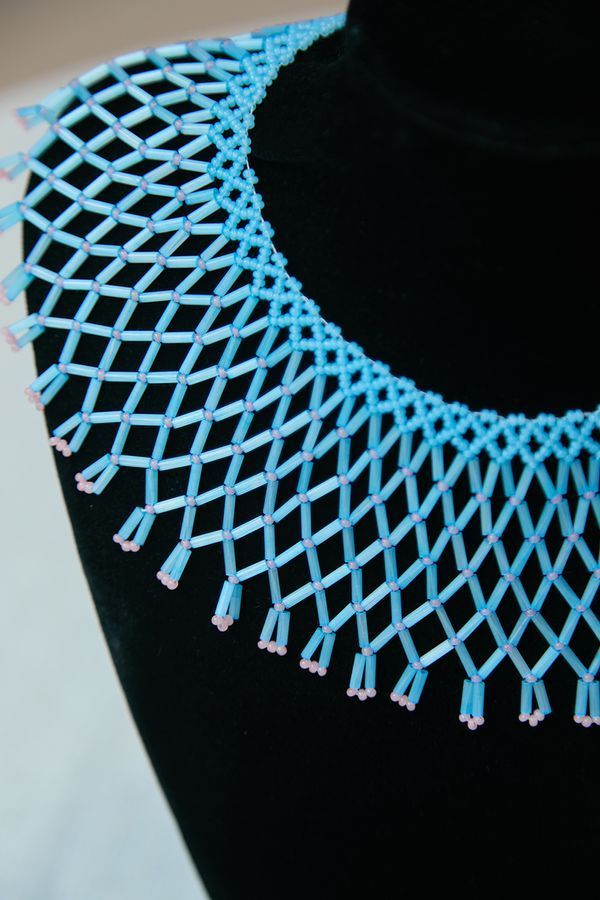 A glass bead necklace, blue with pink