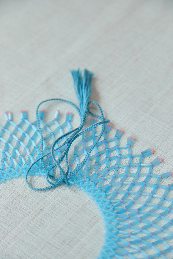 A glass bead necklace, blue with pink
