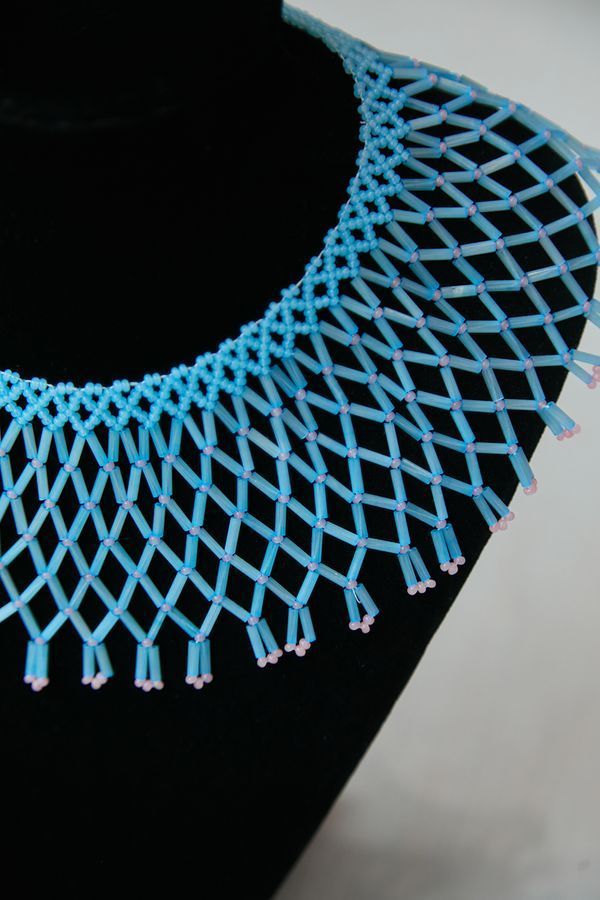 A glass bead necklace, blue with pink