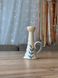 Small milk-colored candleholder with a handle