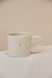 A mug with a gold heart