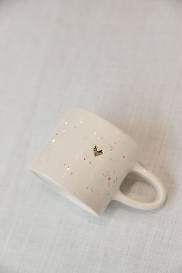 A mug with a gold heart