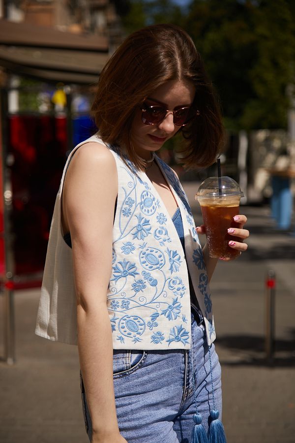 White vest with blue embroidery