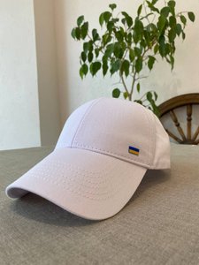 The cap is white with a small flag of Ukraine