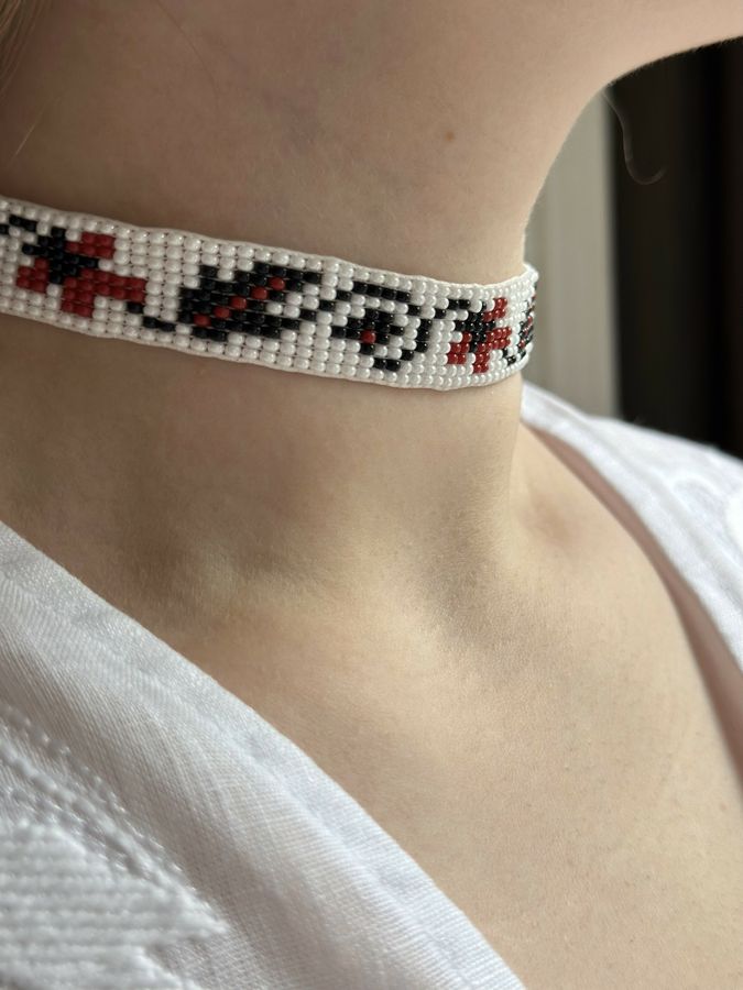 White beaded gerdan with black and red ornaments