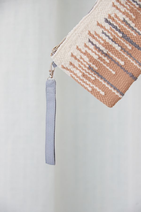 Beige and milky wallet with a wrist strap